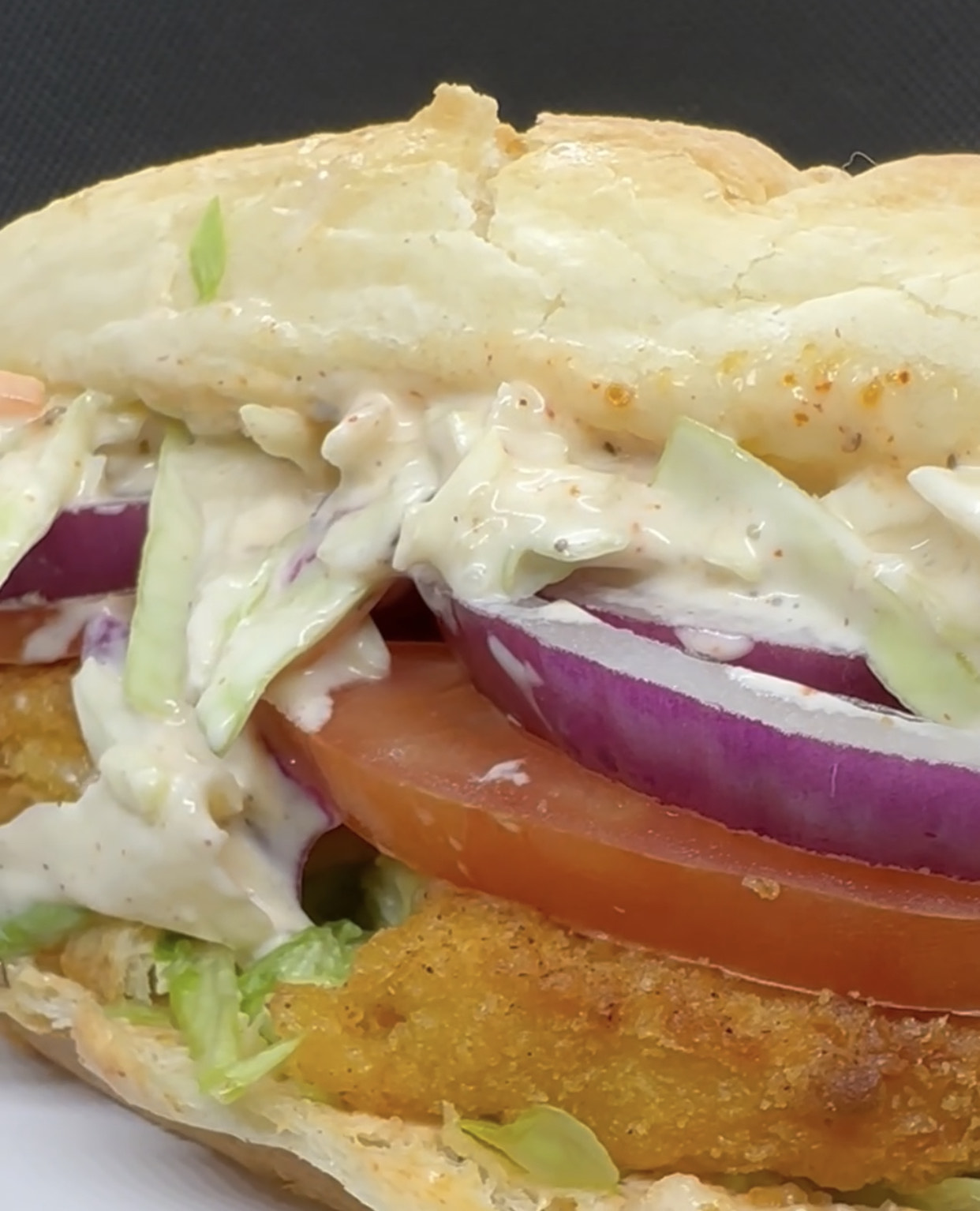Vegan Po'Boy Sandwich with crispy fillets, coleslaw, and remoulade sauce